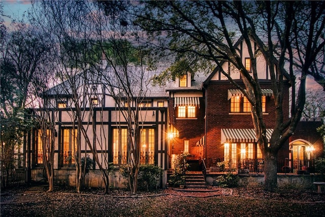 view of back house at dusk