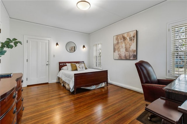 bedroom with dark wood-type flooring