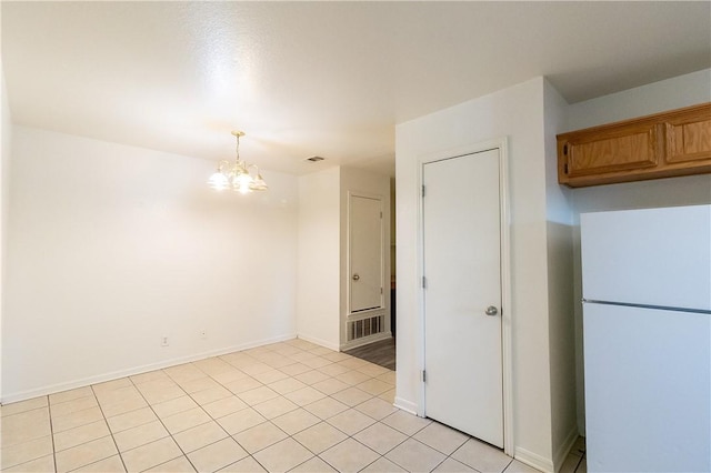 unfurnished room featuring light tile patterned floors and a notable chandelier