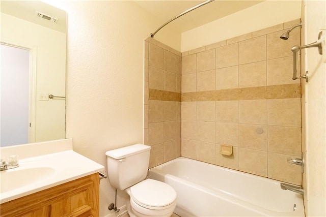 full bathroom featuring vanity, toilet, and tiled shower / bath