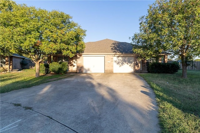 view of front of house featuring a garage and a front lawn