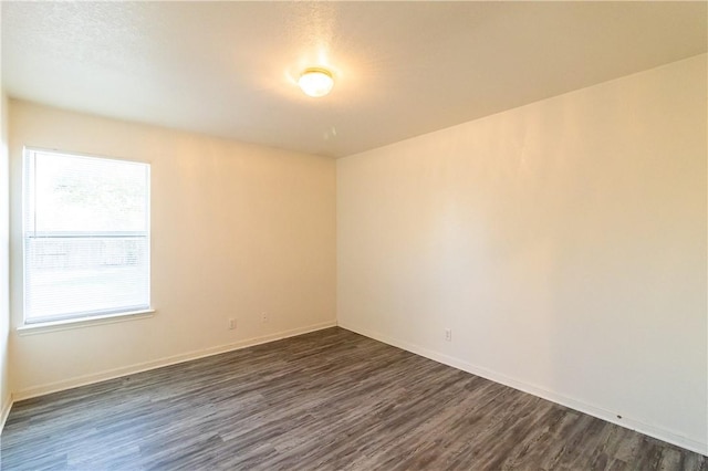 empty room featuring dark hardwood / wood-style flooring