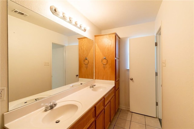 bathroom with tile patterned floors and vanity