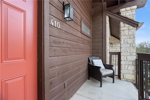 property entrance featuring stone siding