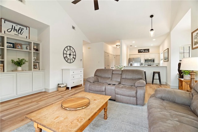 living room with recessed lighting, visible vents, ceiling fan, high vaulted ceiling, and light wood-type flooring