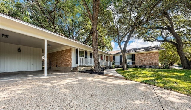 ranch-style home with a carport and a front lawn