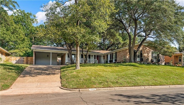 view of front facade with a carport and a front lawn