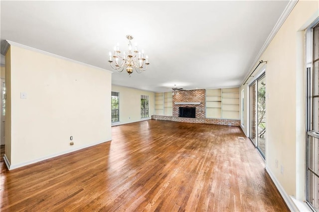 unfurnished living room featuring hardwood / wood-style floors, ceiling fan with notable chandelier, and crown molding