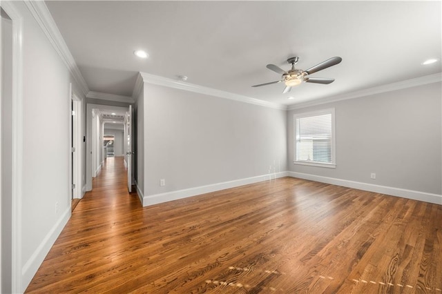 empty room with crown molding, ceiling fan, and hardwood / wood-style flooring