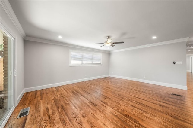 empty room featuring crown molding, ceiling fan, and hardwood / wood-style flooring