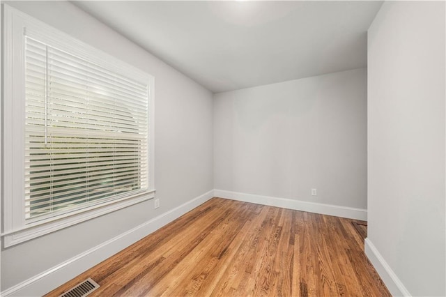 spare room featuring hardwood / wood-style flooring