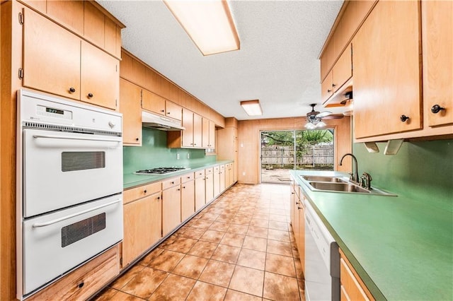 kitchen with a textured ceiling, ceiling fan, white appliances, and sink