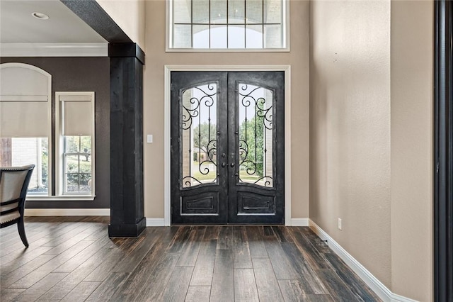 foyer entrance featuring crown molding, french doors, and dark hardwood / wood-style floors