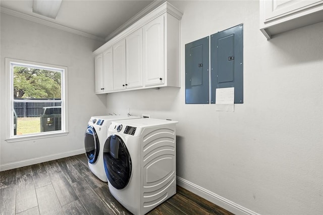 washroom featuring washing machine and clothes dryer, cabinets, dark hardwood / wood-style floors, electric panel, and crown molding