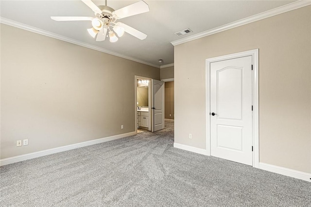 unfurnished bedroom featuring carpet flooring, ensuite bath, ceiling fan, and crown molding