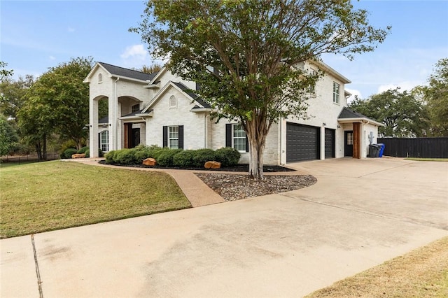 view of front of home with a garage and a front lawn