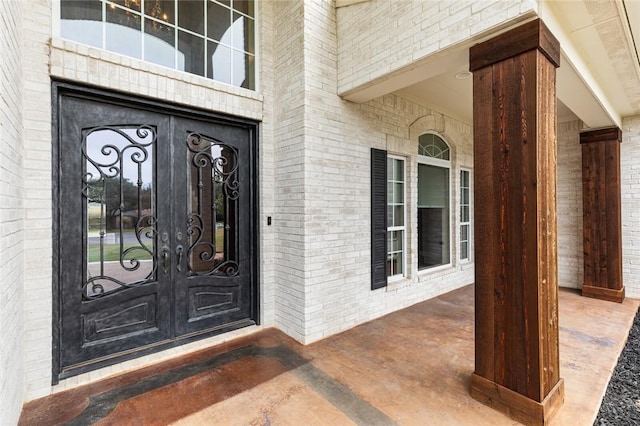 view of exterior entry featuring french doors