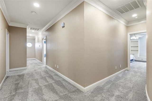 hallway with crown molding and light carpet