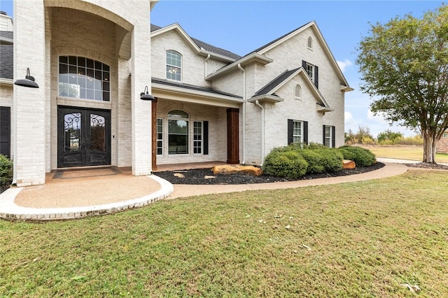 view of front facade featuring a front lawn and french doors