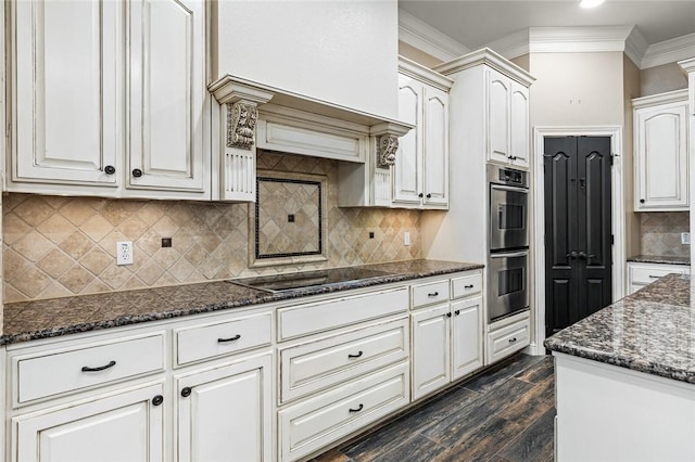 kitchen featuring white cabinetry, black electric cooktop, dark wood-type flooring, and ornamental molding