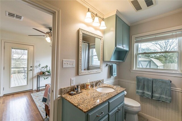 bathroom featuring a wainscoted wall, a wealth of natural light, and visible vents