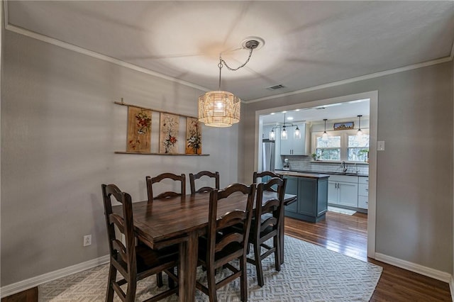 dining room featuring crown molding, visible vents, baseboards, and dark wood-type flooring