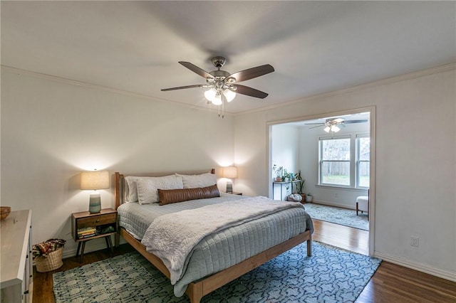 bedroom featuring ornamental molding, a ceiling fan, baseboards, and wood finished floors