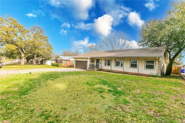 ranch-style home with a garage, driveway, and a front lawn