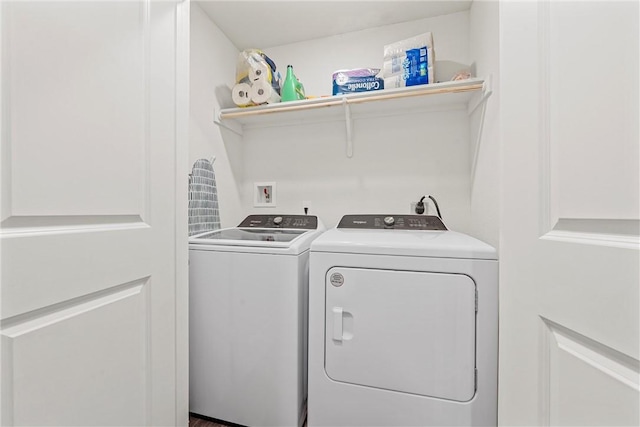 washroom featuring laundry area and washing machine and clothes dryer