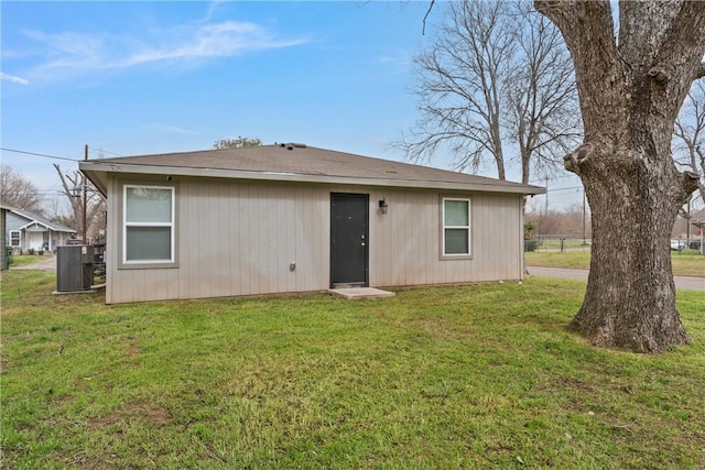 rear view of house with a yard