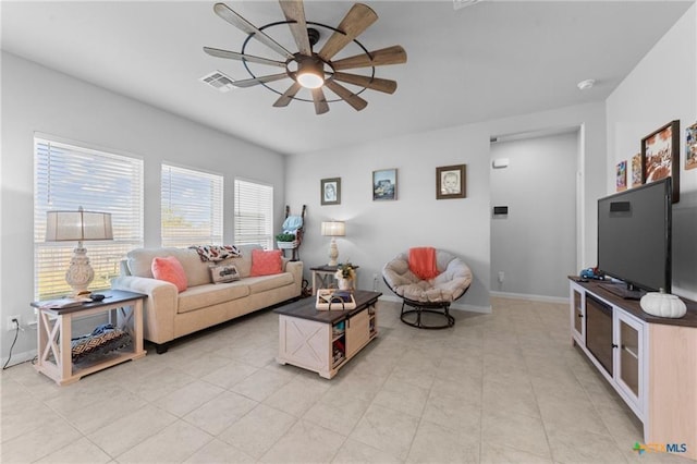 living room with ceiling fan and light tile patterned floors