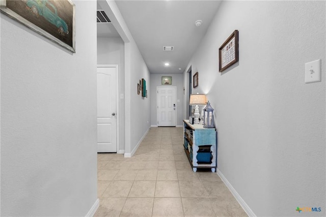 corridor with light tile patterned floors