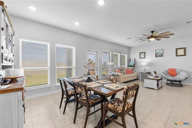 tiled dining space featuring ceiling fan