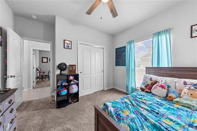 bedroom with ceiling fan, a closet, and light carpet