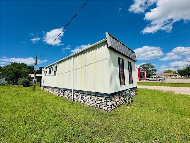 view of side of home featuring a yard