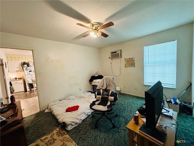 bedroom with a wall unit AC and ceiling fan