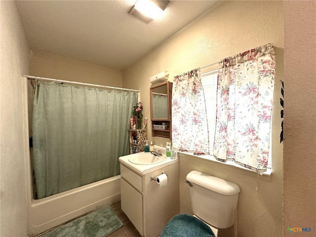 full bathroom featuring vanity, shower / tub combo with curtain, and toilet