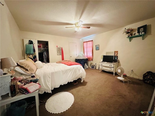 carpeted bedroom featuring ceiling fan, a spacious closet, a closet, and a textured ceiling