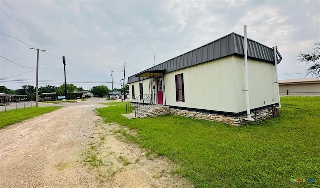 view of side of property with a lawn