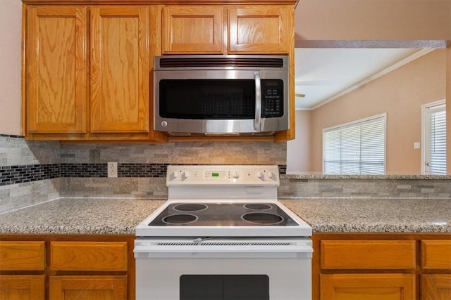 kitchen featuring backsplash, white range with electric stovetop, and crown molding