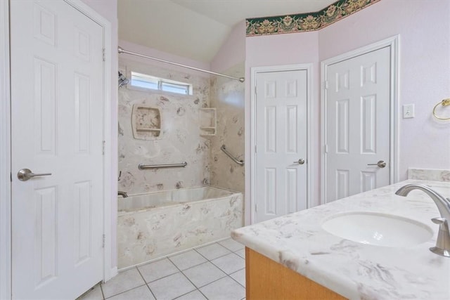 bathroom with tile patterned flooring, vanity, and tiled shower / bath