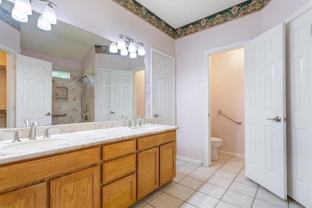 bathroom featuring tile patterned floors, toilet, a shower, and vanity