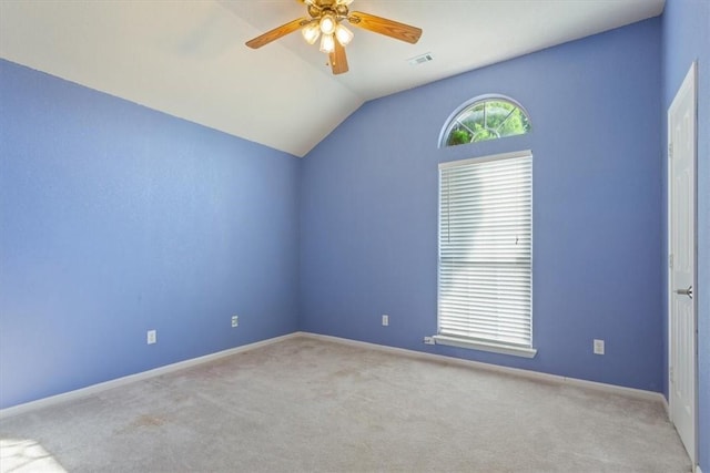 carpeted empty room with ceiling fan and lofted ceiling