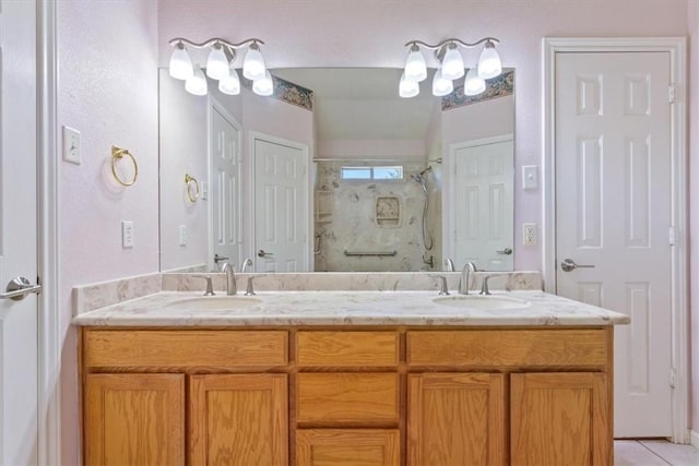 bathroom with tile patterned flooring, vanity, and walk in shower