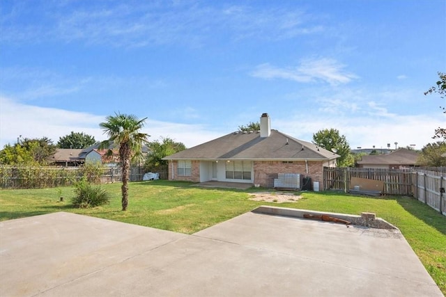 back of property featuring a lawn and a patio area