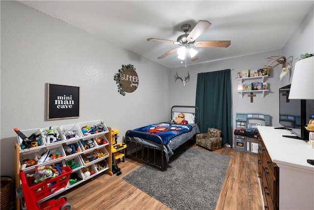 bedroom with wood-type flooring and ceiling fan