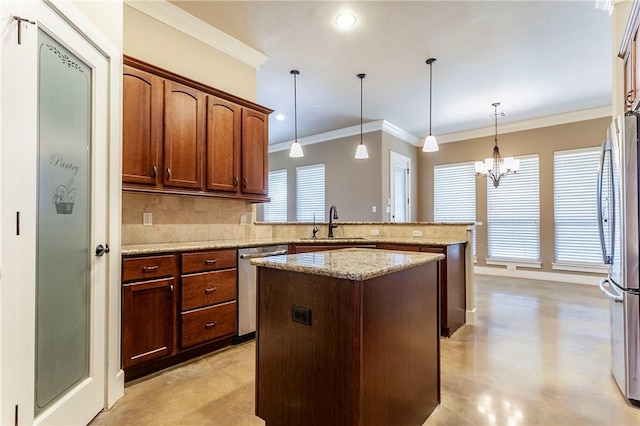 kitchen with kitchen peninsula, appliances with stainless steel finishes, backsplash, ornamental molding, and decorative light fixtures