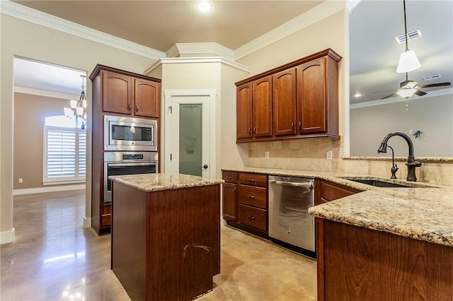 kitchen featuring appliances with stainless steel finishes, hanging light fixtures, crown molding, and sink