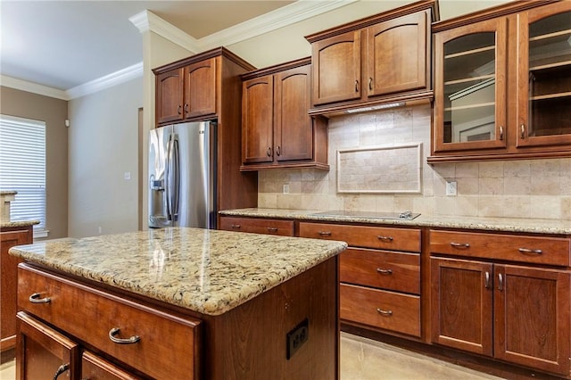 kitchen featuring decorative backsplash, light stone countertops, ornamental molding, black electric cooktop, and stainless steel fridge with ice dispenser