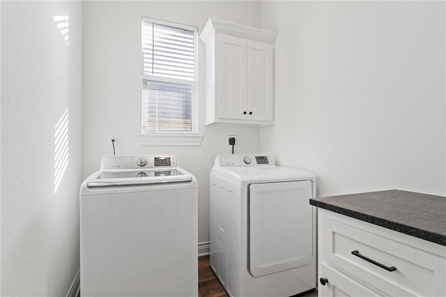 washroom featuring cabinet space, independent washer and dryer, and dark wood-style floors